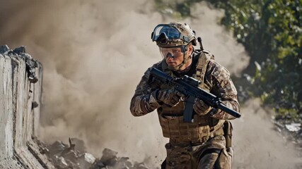 Soldier in tactical gear running past an explosion with debris and dust flying in a combat zone or training exercise