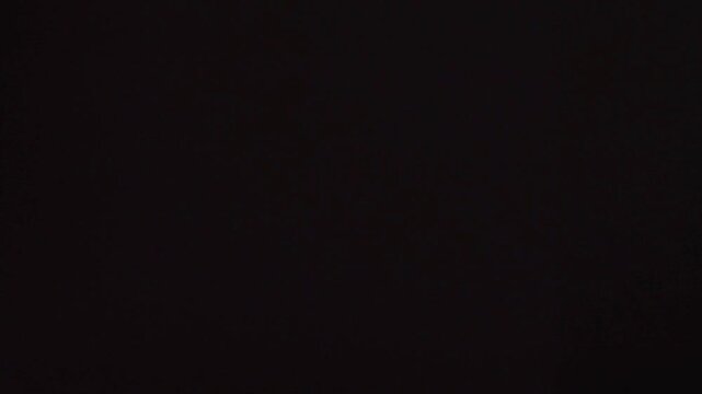 Dark grunge texture with black smoke and red flame explosion transition for an abstract movie opening