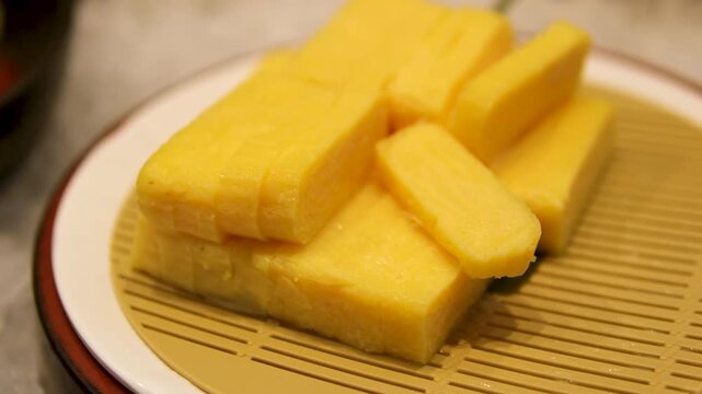 Tahu takwa tahu kuning, tahu yellow tofu, traditional tofu from Kediri, East Java.This yellow color is tofu soaked with turmeric. High quality 4k footage