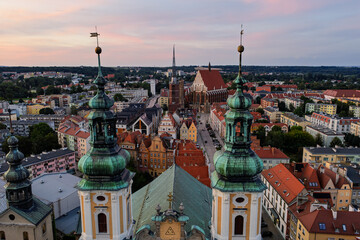 Aerial drone sunset view of Nysa historic town square and church in Opole Poland, golden hour on Renaissance baroque architecture, cobblestone market, cathedral tower, red rooftops