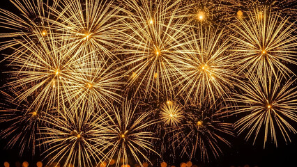 Golden fireworks exploding in the night sky creating a dazzling display