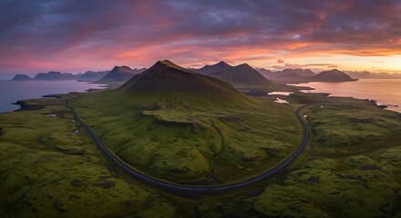 Icelandic landscape with winding road and colorful sunset sky