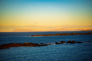 Golden sunset over coastal landscape