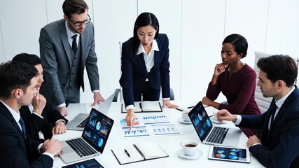Diverse business team collaborating in a meeting, analyzing financial data and charts displayed on laptops and paper documents - Powered by Adobe