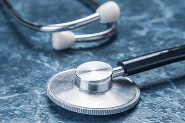 Stethoscope on blue background, medical equipment and healthcare concept