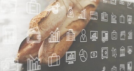Cradling pair of hands holding two long baguettes on bakery countertop, with finance icons