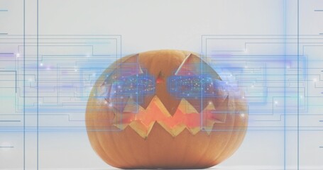 Naklejka premium Glowing jack-o-lantern on tabletop, displaying triangular eyes zigzag mouth and blue HUD overlays