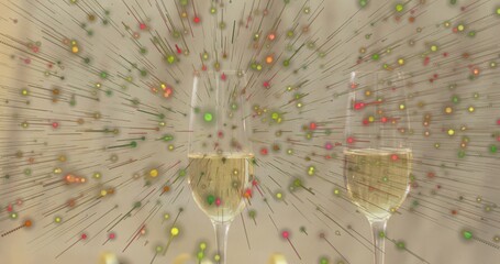 Displaying paired champagne flutes with bubbles on reflective tabletop, colorful particle burst © vectorfusionart
