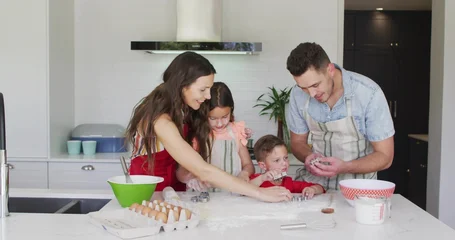 Selbstklebende Fototapeten Zu Kochen Baking family of four preparing dough at home kitchen island, using cookie cutters, wearing aprons  © vectorfusionart