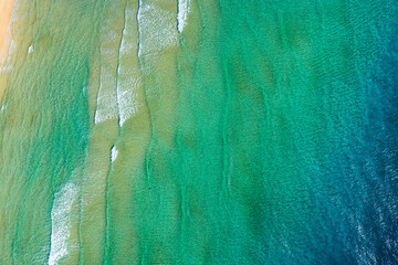 Playa de Sotavento is a famous beach on the southeastern coast of Fuerteventura, known for its long stretches of golden sand, turquoise water, and consistent winds