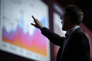 An economist presenting economic growth data.