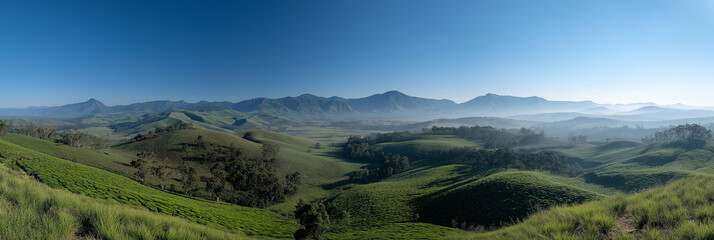 Obraz premium Expansive panoramic valley reveals layered mountain ridges under clear bright sky.