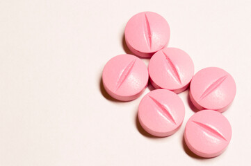 pink pills on white background