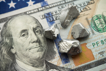 Rare earth element on US dollar bill banknote, American flag background. US vs China chip war, tech...