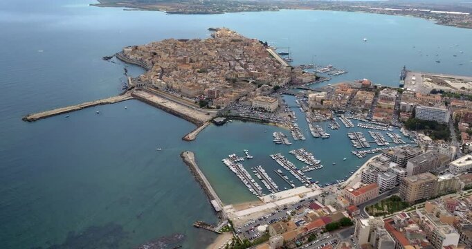 Panorama of the island of Ortigia, Sicily, Italy. View from above of the historic center of Syracuse, located along the coast of the Mediterranean. The city is a destination for many tourists.
