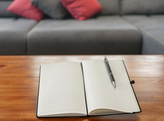 Close-up of an Open Planner on a Wood Desk