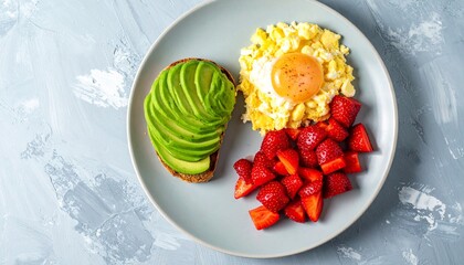 Start your day with a vibrant, wholesome breakfast of avocado toast, scrambled eggs, and fresh strawberries for energy and wellness