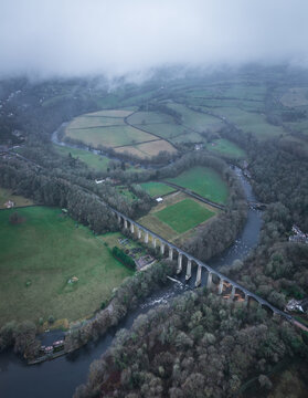 Aerial view of the Pontcysyllte Aqueduct, a testament to engineering prowess, slicing through the landscape where the River Dee meanders, Llangollen, Wales, United Kingdom.