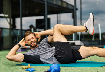Portrait of  healthy fit man doing crunches at the gym exercising in fitness club, healthy life,...