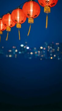 Seamless loop animation of glowing red paper Chinese lanterns swaying gently in the wind, creating a festive background for Lunar New Year and Year of the Horse 2026 celebrations