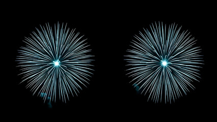 Fototapeta premium Two bright cyan blue fireworks exploding in a symmetrical starburst pattern against a deep black night sky background
