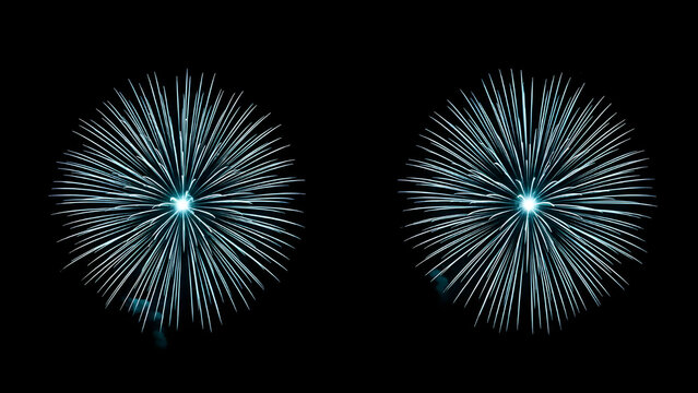 Two bright cyan blue fireworks exploding in a symmetrical starburst pattern against a deep black night sky background