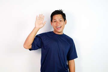 Happy Man in Navy T‑Shirt Waves Hands Up With Friendly Smile Portrait