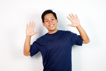 Happy Man in Navy T‑Shirt Waves Hands Up With Friendly Smile Portrait