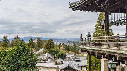 People enjoying the view from Todai-ji Nigatsu-do temple on top the hill in Nara, Honshu island in Japan