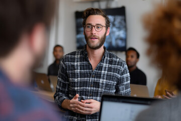 Fototapeta premium A diverse team collaborating on a project in a modern workspace.