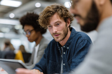 A diverse team collaborating on a project in a modern workspace.