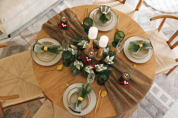 Festive table setting with Christmas decor indoors, above view