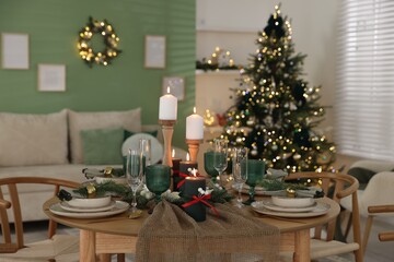 Festive table setting with Christmas decor indoors