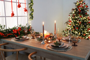 Festive table setting with Christmas decor indoors