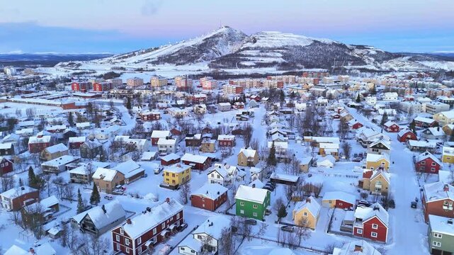 Kiruna, Lapland, Sweden, beautiful aerial view of the colorful houses and of the hill with ski slopes, during the arctic winter and polar night