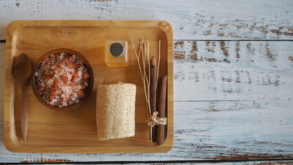 Naklejka na ściany i meble Top view Himalayan pink salt crystals on wooden board, scrub spa therapy healthy.spa relax