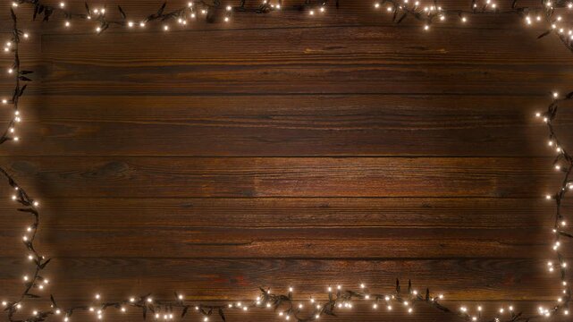 A loop of Christmas lights is framed against a rustic wooden backdrop. The garland is rendered with a touch of realism on aged wooden planks.