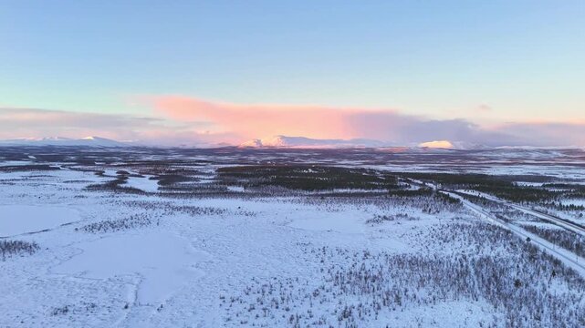 Sunset over arctic mountains landscape in Lapland, Sweden, road and railroad between Kiruna and Narvik
