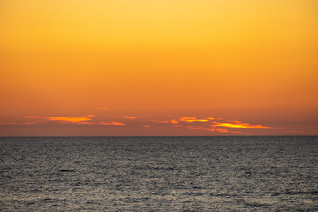 Glowing orange clouds over the dark Atlantic Ocean after sunset Portugal, Ovar – Furadouro, 10.10.2025