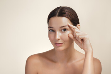 Natural Beauty Woman Pointing At Eye Area For Skincare Concept