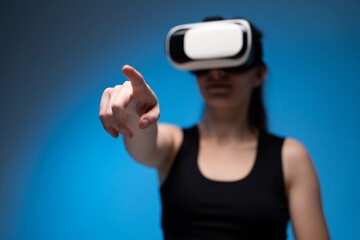 VR designer interacting with virtual workspace by pointing forward toward digital interface elements