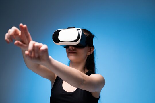 Virtual reality designer extending hands to interact with immersive digital interface and creative workspace