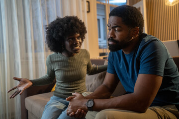 African woman angry at inactive partner showing dissatisfaction in relationship