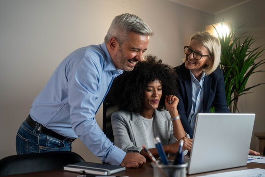 Diverse business team exchanging ideas and analyzing project results in office