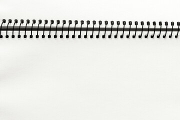 Open spiral notebook with blank empty cloud white dancer sheets, closeup top view, paper background. Demonstrating color, trend 2026 year.