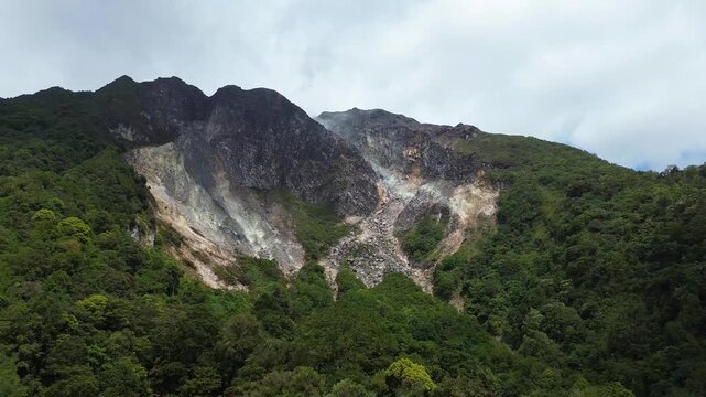 A geothermal volcanic mountain with sulfur fumaroles and rising steam seen from above