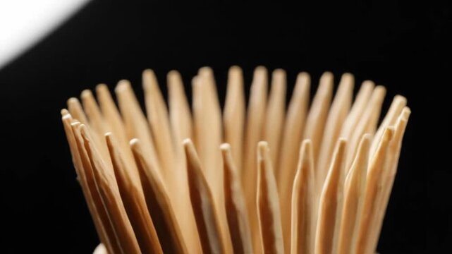 Wooden Toothpick Cluster - A close-up shot showcases a cluster of wooden toothpicks, focusing on their sharp tips and intricate wood textures.
