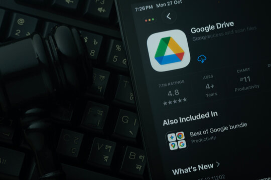 Dhaka, Bangladesh- 28 Oct 2025: An iPad displaying the Google Drive app against a judge's gavel and dark keyboard background.