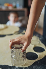 Child Engaging In Baking By Pressing Pastry Cutters Into Flourcoated Rolled Dough While Forming Cookies