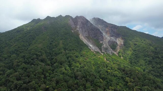 A dramatic volcanic mountain with active fumaroles viewed from above